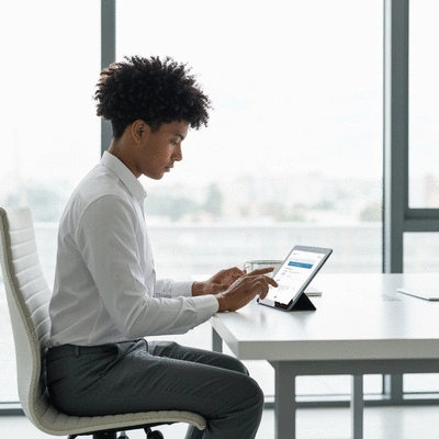Person using a tablet to manage an online business profile, clean modern design, bright office setting